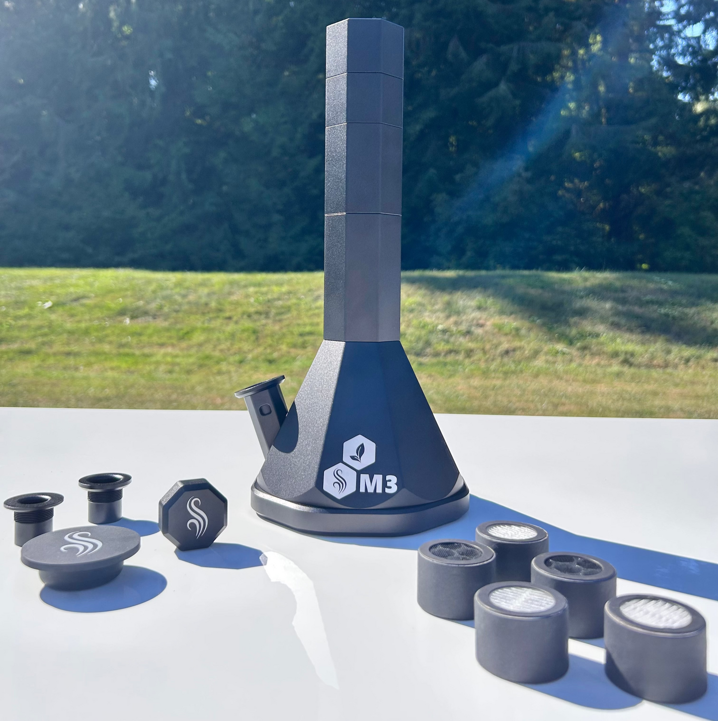 Black M3 Pro with accessories and 5 M2/M3 M Series filters on a white surface outdoors
