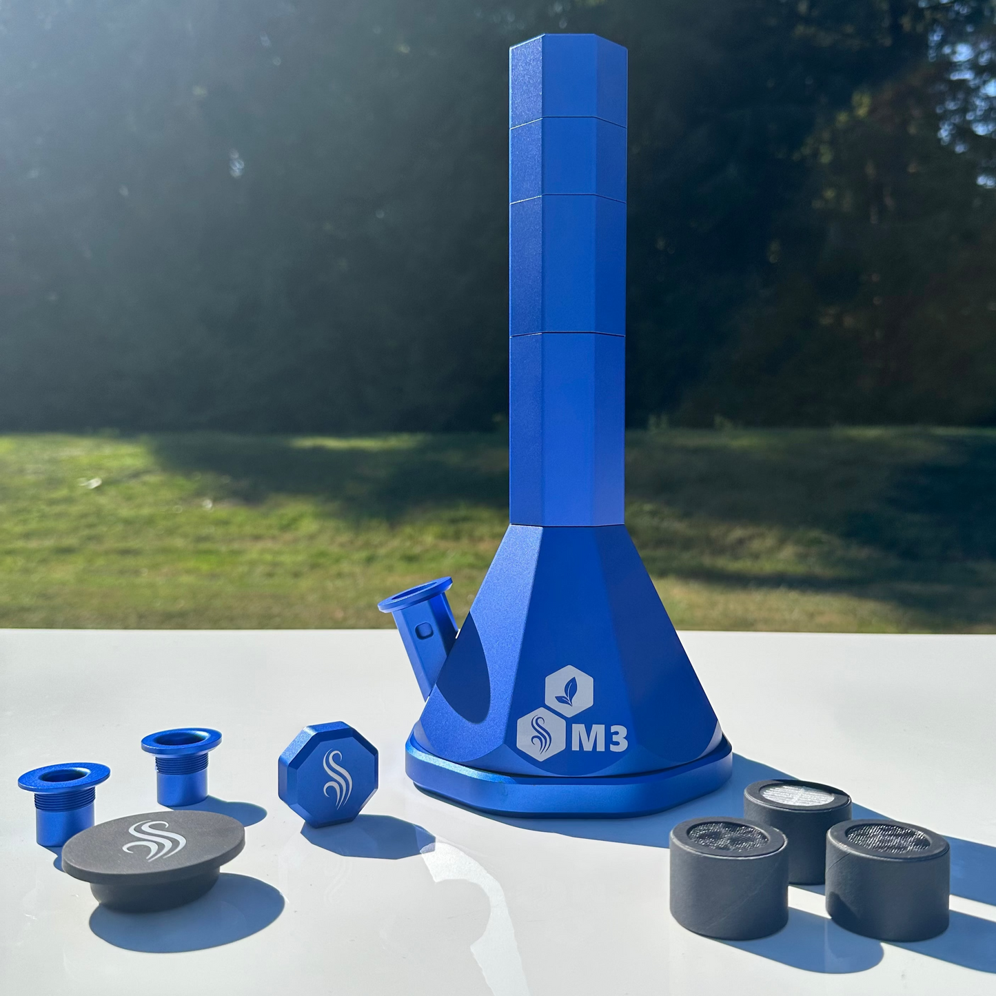 Blue M3 Pro with accessories and 3 filters on a white surface outdoors
