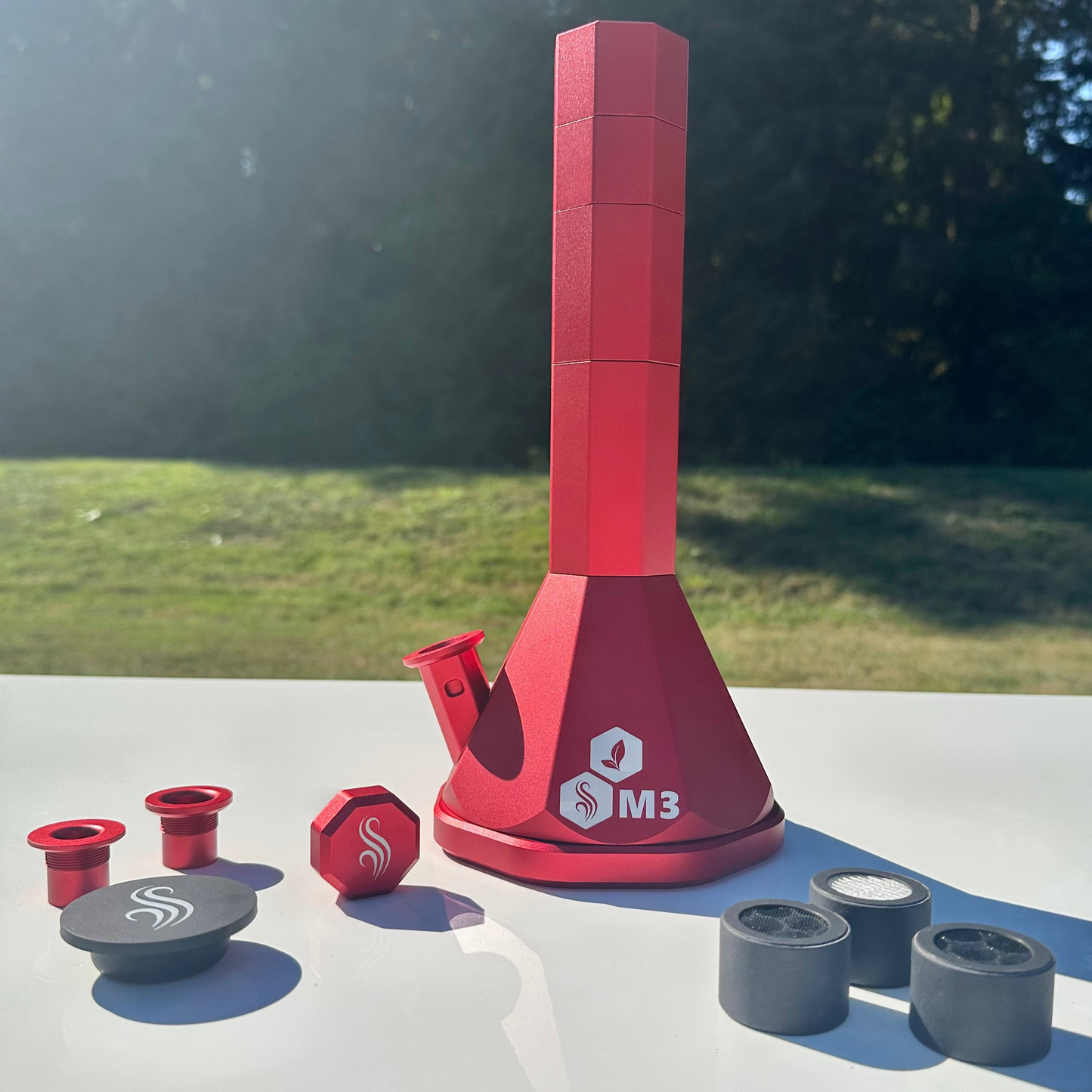 Red M3 Pro with accessories and 3 M2 M3 M Series filters on a white surface outdoors