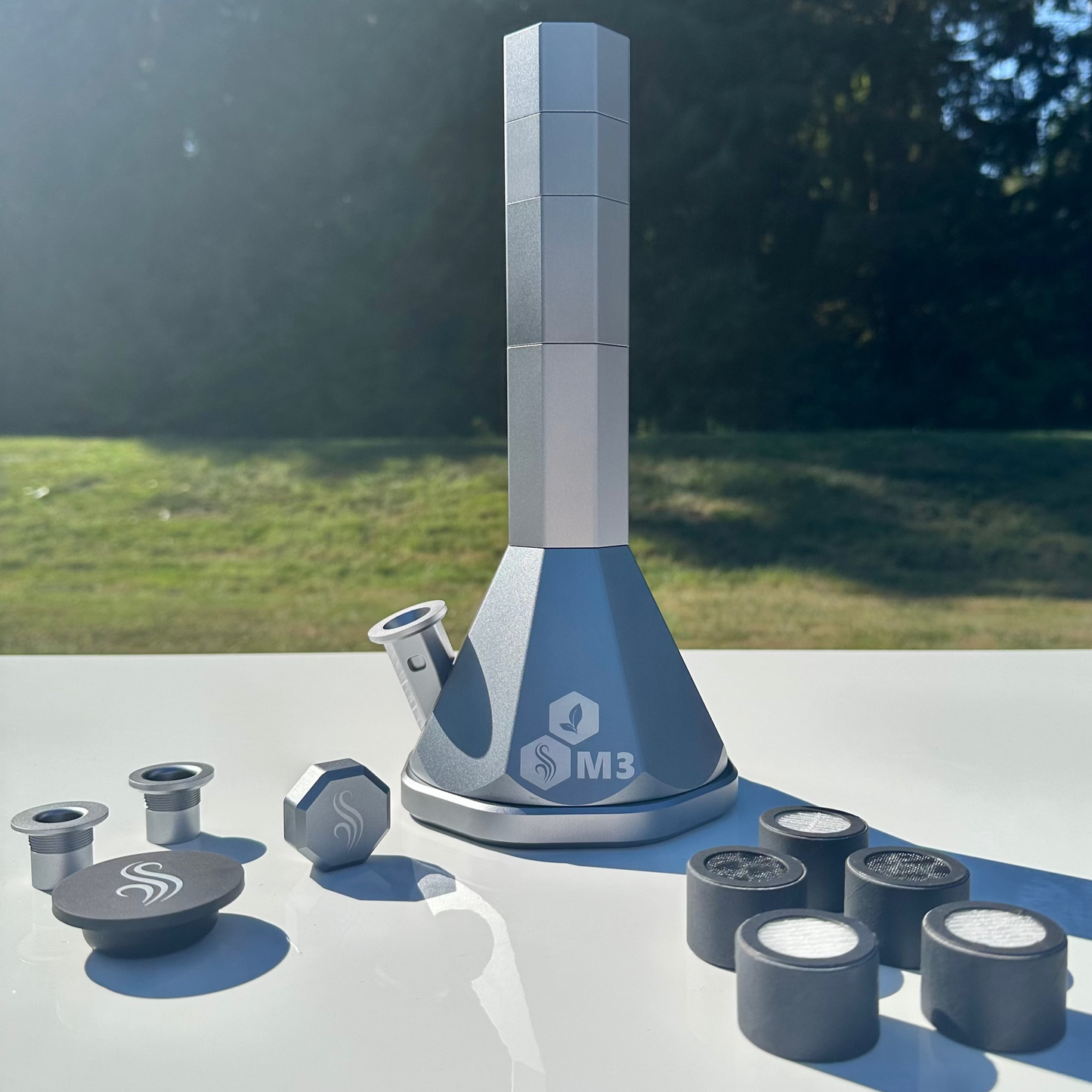 Silver M3 Pro with accessories and 5 M Series filters on a white surface outdoors