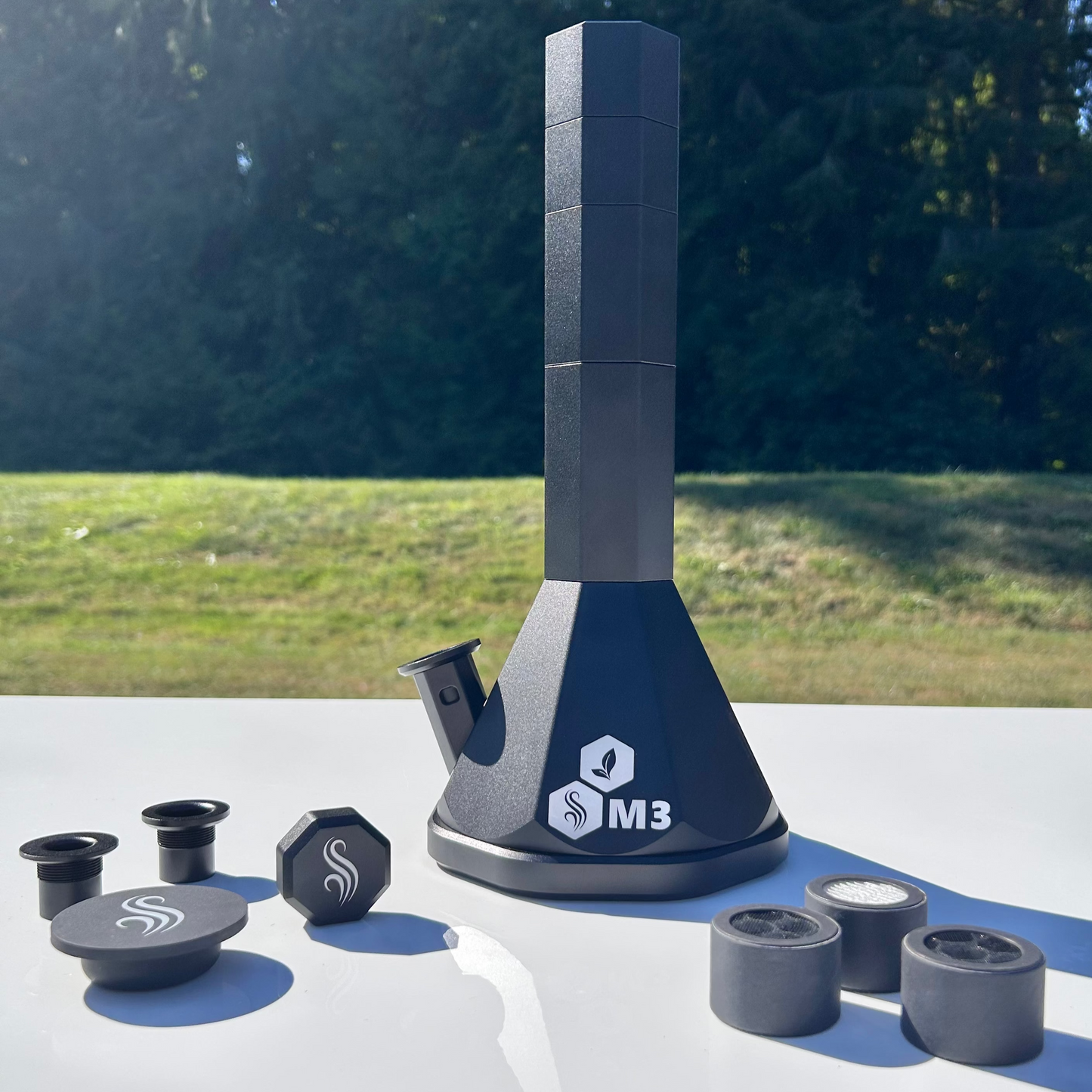 Black M3 Pro with accessories and 3 M2/M3 M Series filters on a white surface outdoors