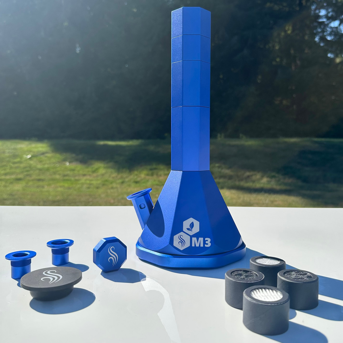 Blue M3 Pro Bong with accessories and 4 M2/M3 M Series filters on a white surface outdoors