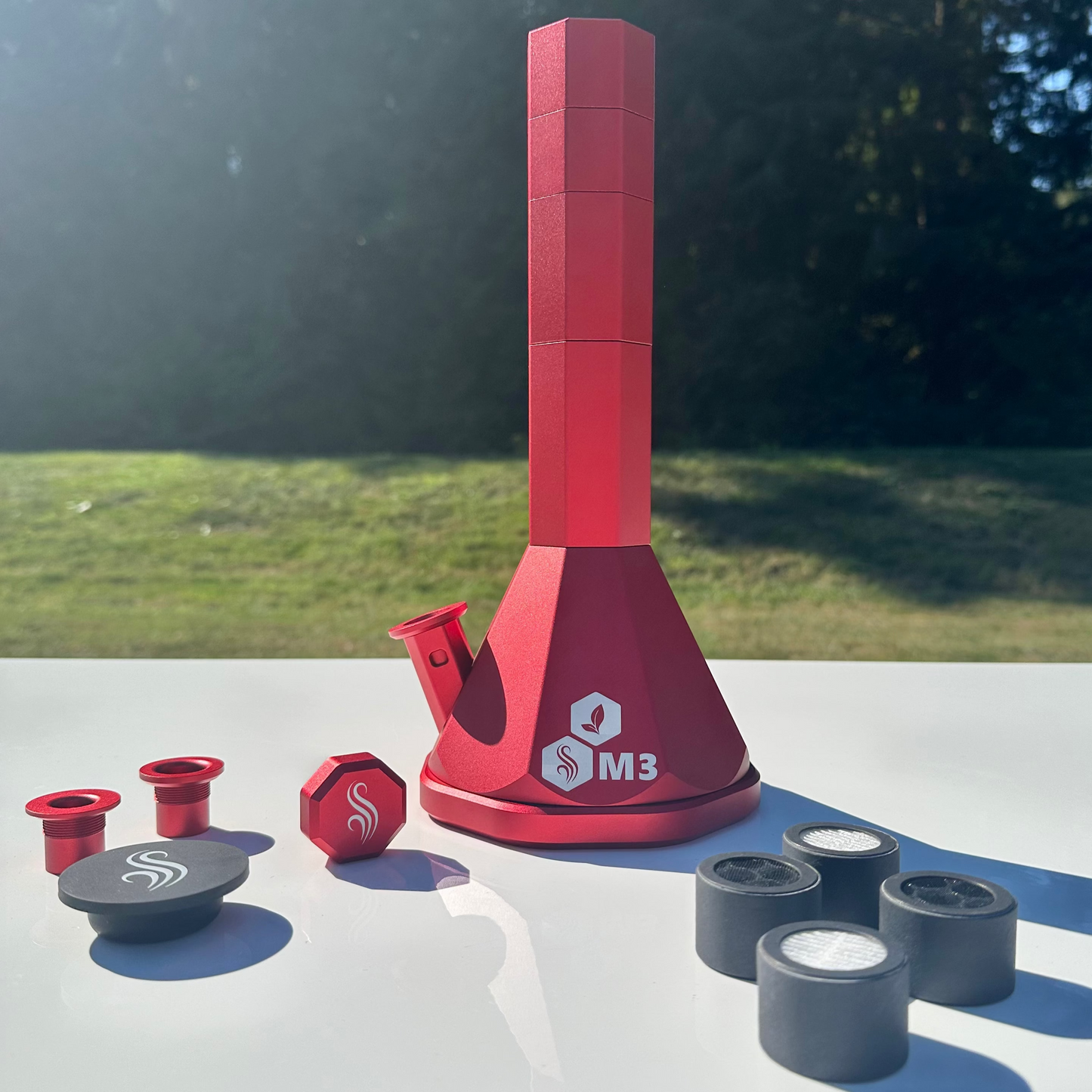 Red M3 Pro with accessories and 4 M2/M3 M Series filters on a white surface outdoors