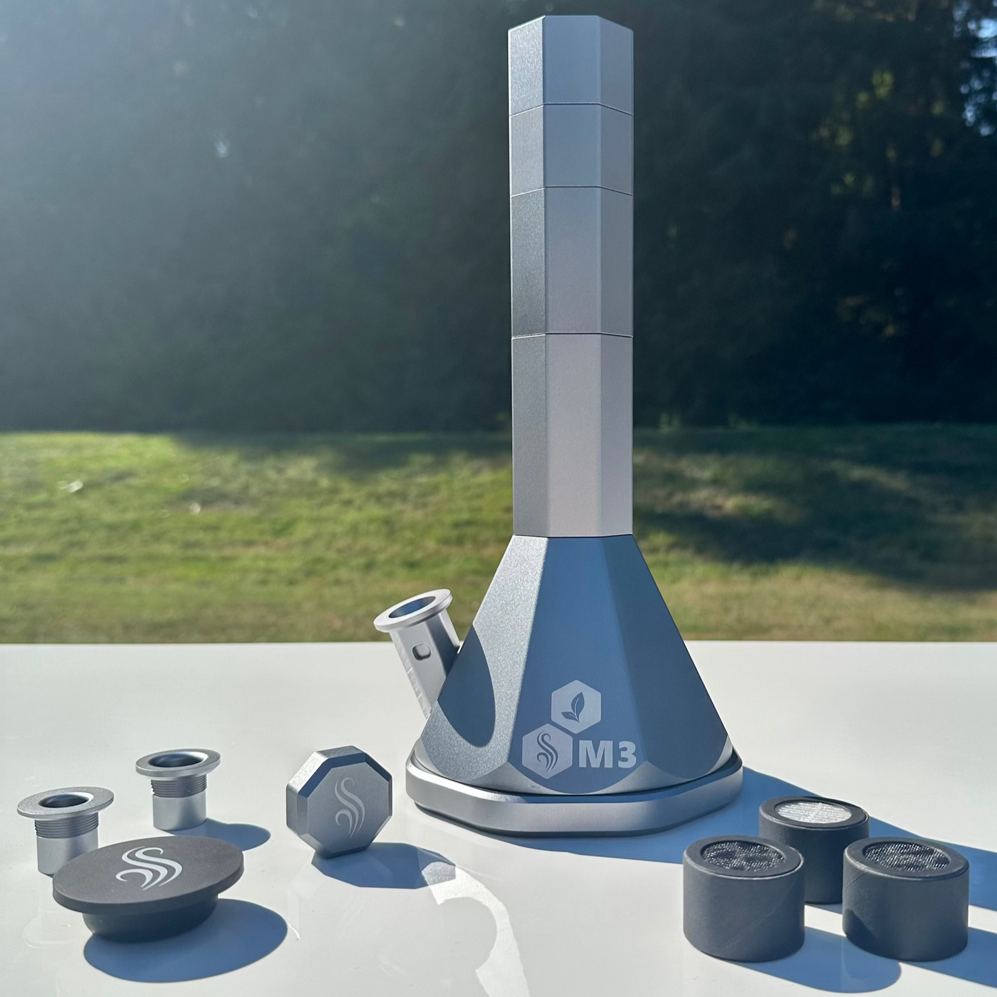 Silver M3 Pro with accessories and 3 M Series filters on a white surface outdoors