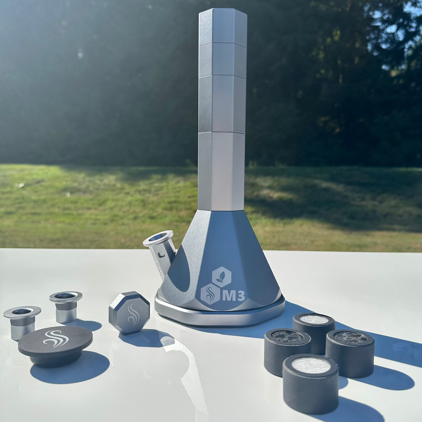 Silver M3 Pro with accessories and 4 M Series filters on a white surface outdoors